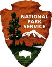 NPS_Logo A national park service logo with trees and mountains in the background.